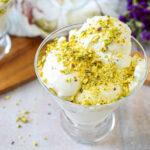 Mastic Ice Cream in a glass bowl with crushed pistachios over the top.