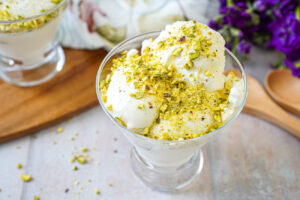 Mastic Ice Cream in a glass bowl with crushed pistachios over the top.