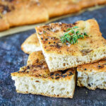 A stack of Eastern-Style Focaccia topped with thyme sprigs.