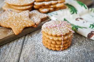 A stack of round Piparkakut (Finnish Gingerbread Cookies) tied with a red thread.