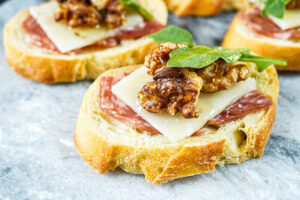 Salami Pecorino Crostini on a marble board.