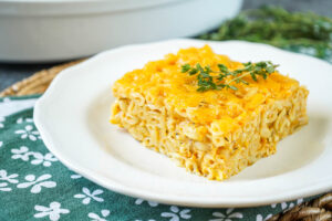 A slice of Trinidad Macaroni Pie on a white plate.