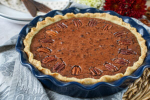 Brownie Pecan Pie in a blue pie dish.