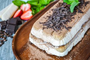 Semifreddo al Tiramisù (Tiramisu Semifreddo) on a wooden board.