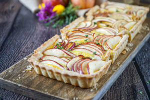 Apple and Caramelized Onion Tart on a wooden board.