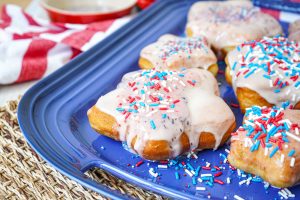 Star-Shaped Doughnuts on a blue platter with red, white and blue sprinkles.