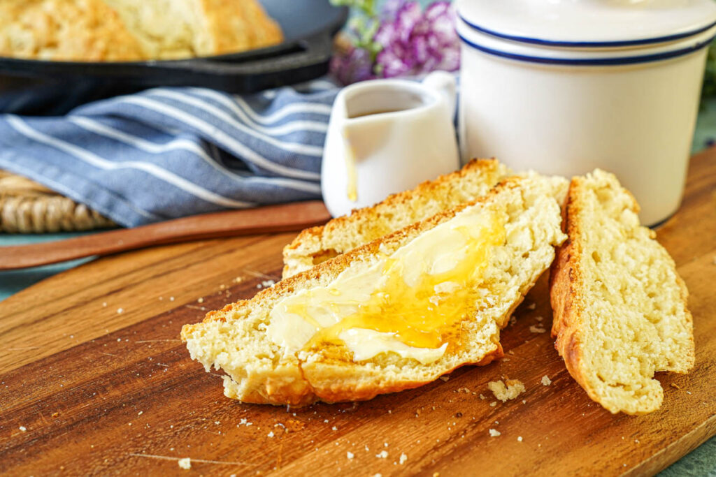 Australian Damper cut into slices and topped with butter and golden syrup.