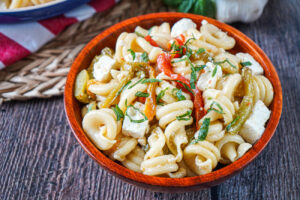Pasta Salad with Grilled Peppers and Feta in a wooden bowl.