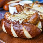 Beer Bratwurst with Caramelized Onions and Gruyère cheese on pretzel bread.