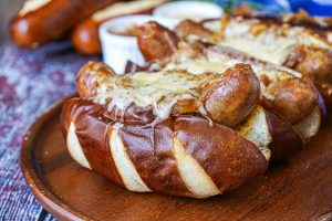 Beer Bratwurst with Caramelized Onions and Gruyère cheese on pretzel bread.