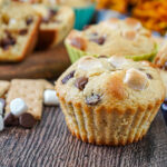 S'mores Muffins next to graham crackers, mini marshmallows, and milk chocolate chips.