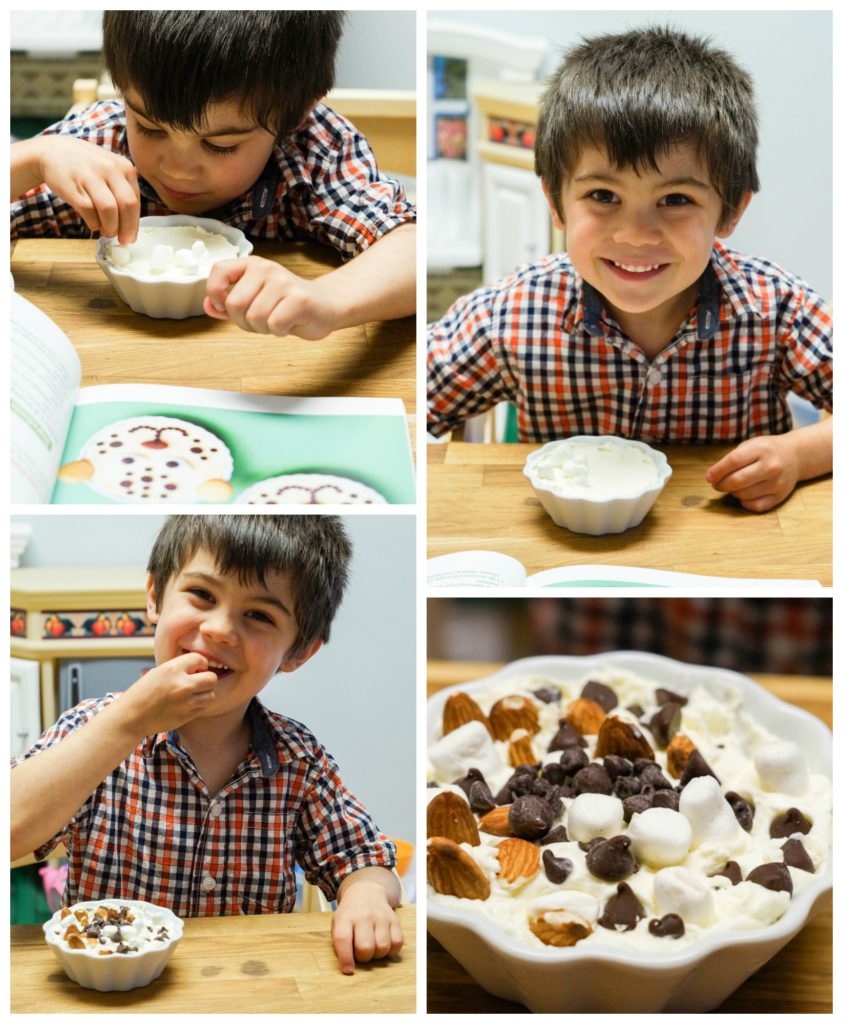 Boy piling the Cheetah Cheesecake with lots of marshmallows and chocolate chips.