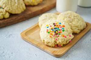 Three Grandmother's Sugar Cookies on a wooden board.