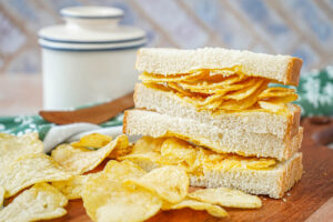 Irish Crisp Sandwich cut in half and stacked next to a pile of crisps.