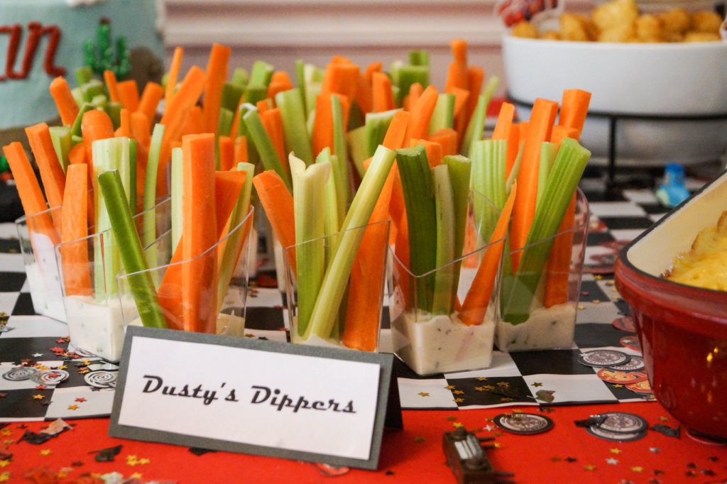 Carrots and celery in little cups with ranch dressing and sign- Dusty's Dippers.