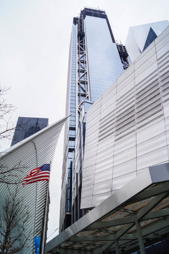 Entrance to the 9/11 Memorial & Museum with an American flag.