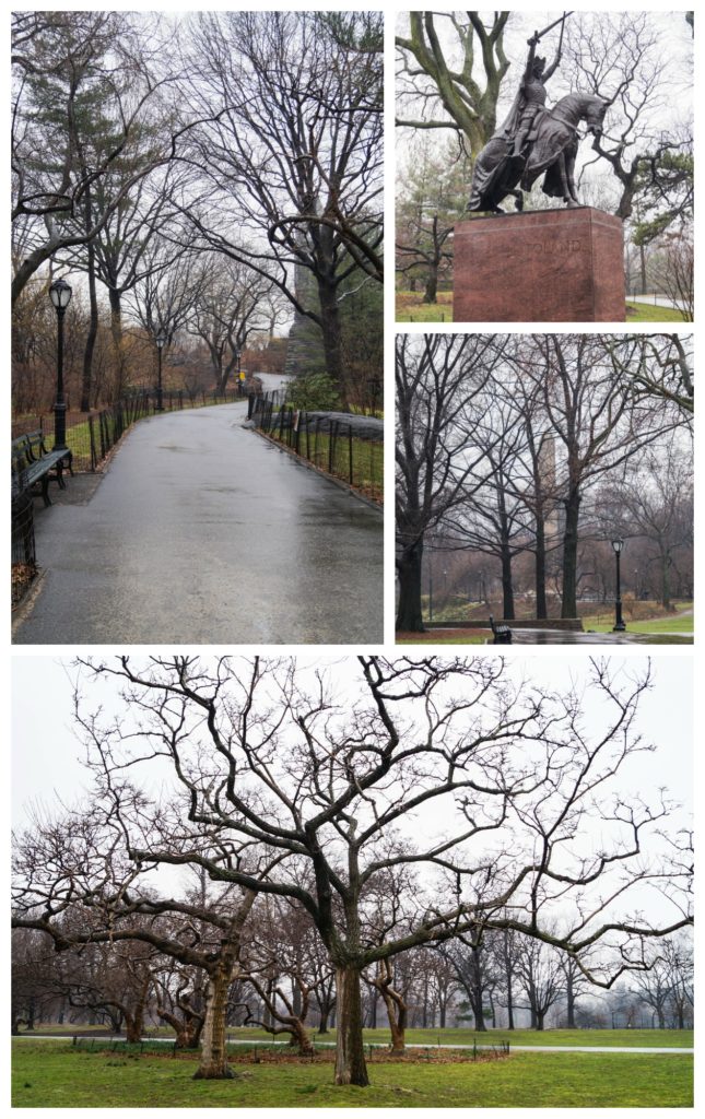 Sidewalk in Central Park with bare trees and a statue of knight on horse.