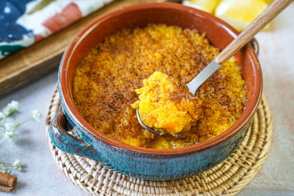 Spoon with a scoop of Encharcada (Portuguese Soaked Eggs).