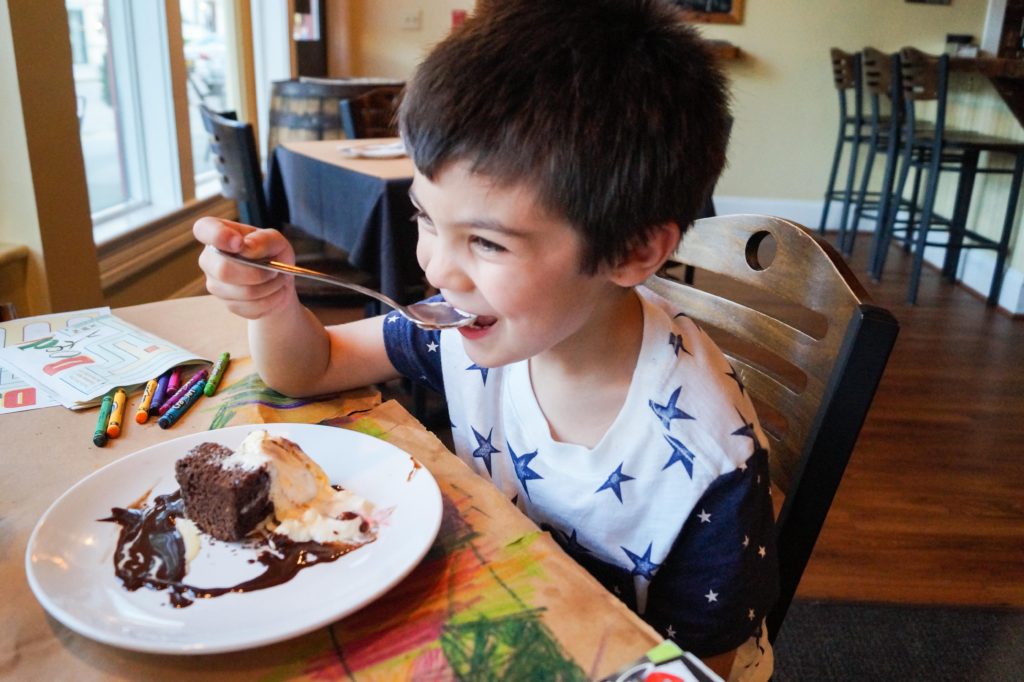 Boy eating cake at The High Spot Gastropub.