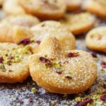 Afghani Gosh-e-Fil (Elephant Ear-Shaped Fried Pastry) topped with rose petals and crushed pistachios.