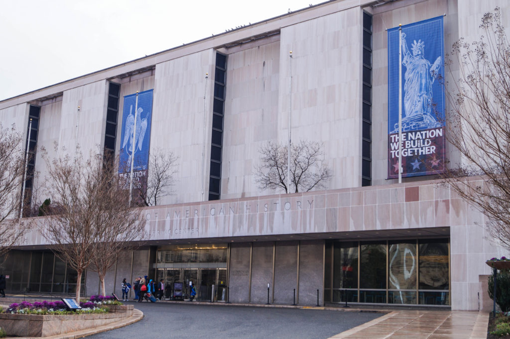 Entrance to Smithsonian National Museum of American History with banner of the Statue of Liberty: The Nation We Build Together