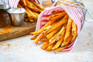 Boardwalk Fries wrapped in red and white-striped paper.