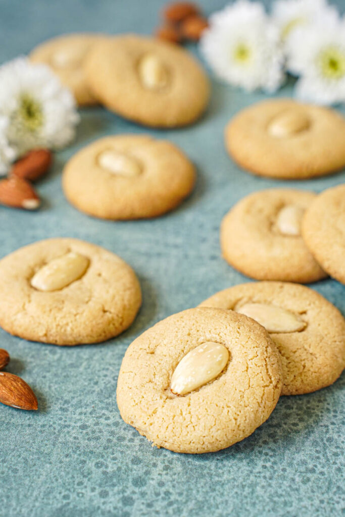 Close up of Tahina Cookies topped with blanched almonds.