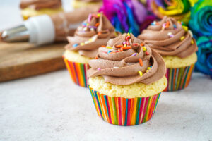 Nutella Buttercream Frosting on three vanilla cupcakes.