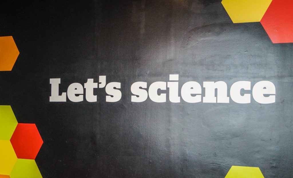Wall at the Maryland Science Center that says "Let's Science."