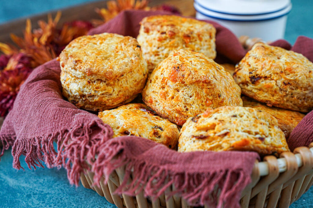 Side view of Cheddar Sun-Dried Tomato Biscuits in a basket.