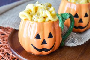 Pumpkin Mac and Cheese in two pumpkin-shaped mugs.