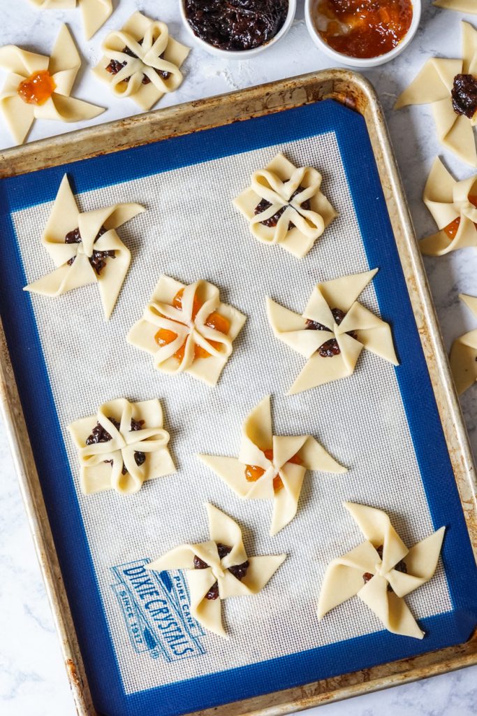 Joulutorttu (Finnish Christmas Tarts) #ChristmasSweetsWeek Aerial view of Joulutorttu (Finnish Christmas Tarts) on a baking sheet.