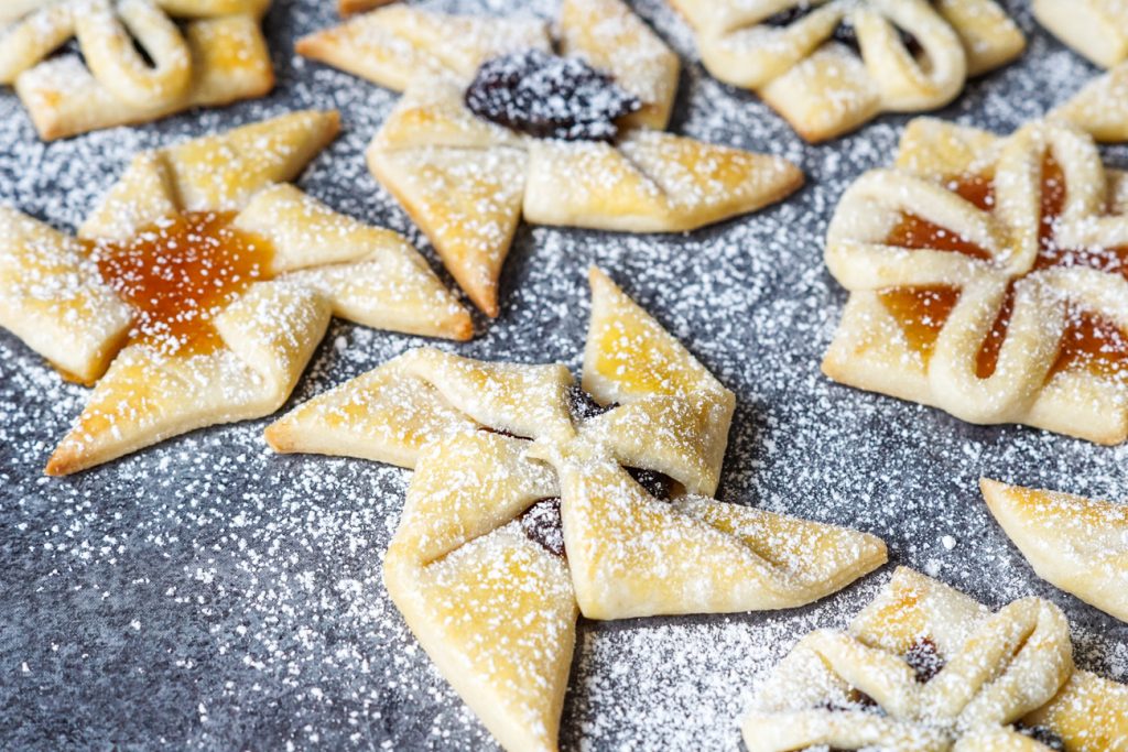 Joulutorttu (Finnish Christmas Tarts) #ChristmasSweetsWeek Star and flower shaped Joulutorttu (Finnish Christmas Tarts) covered in powdered sugar.