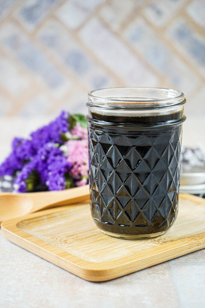 Side view of Homemade Teriyaki Sauce in a glass jar.