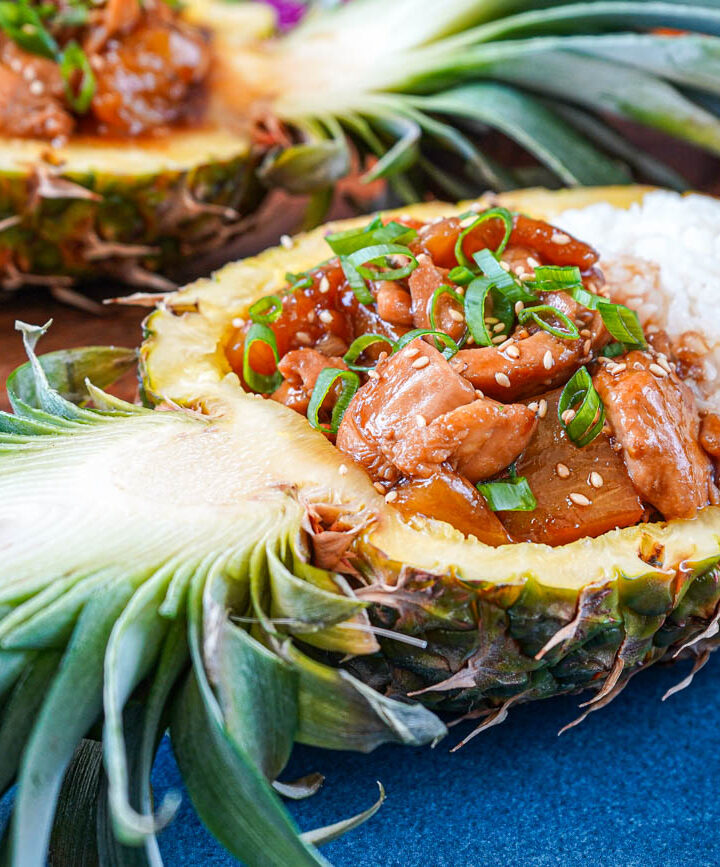 Pineapple Teriyaki Chicken in two pineapple halves with steamed white rice.