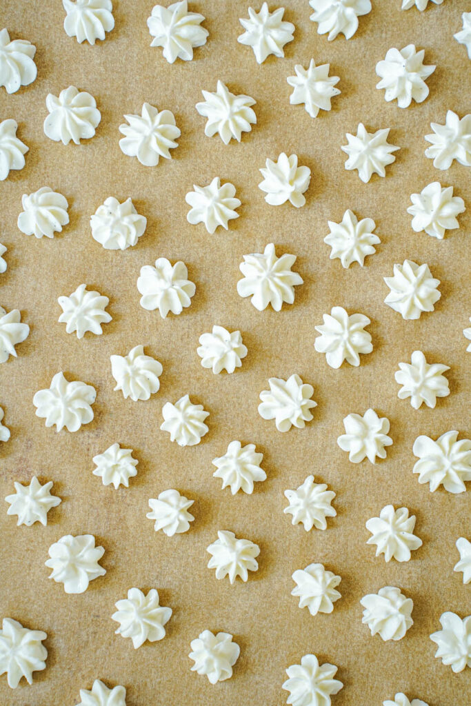 Aerial view of Vanilla Bean Frozen Yogurt Drops on a piece of tan parchment.