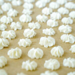 Vanilla Bean Frozen Yogurt Drops on a tan piece of parchment.