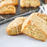 Three Irish Cream Scones with more in the background on a marble board.