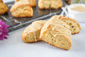 Three Irish Cream Scones with more in the background on a marble board.