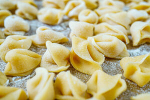 A layer of Sopresine (Homemade Little Surprises) on a semolina-dusted baking sheet.