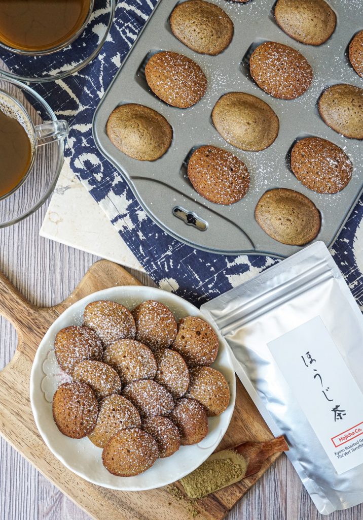 Hojicha Madeleines Aerial view of Hojicha Madeleines with a few on a white plate and more in a Madeleine pan.