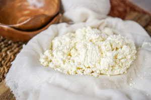 Crumbled Chaana (Fresh Unripened Cheese) on a cheesecloth.