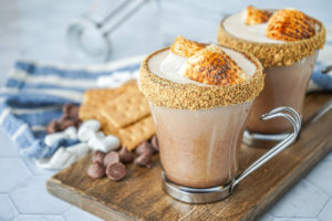 S'mores Latte in two clear glasses and topped with toasted marshmallows.