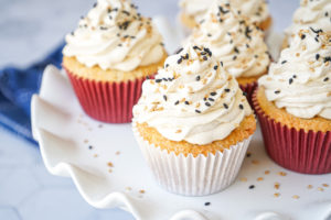 Six Salted Tahini Cupcakes on a white platter.