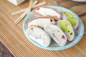 Six slices of Mochi Ice Cream on a blue flower plate.