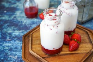 Korean Strawberry Milk in two glass jars.
