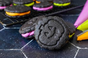 Homemade Chocolate Sandwich Cookies with purple, green, and orange frosting.