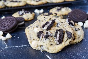 Cookies and Cream Cookies on a black background with white chocolate chips.