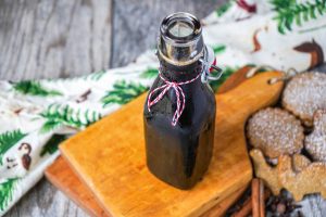 Homemade Gingerbread Syrup in a glass bottle with a red thread.