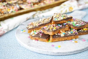 A pile of Chocolate Almond Toffee on a marble board.
